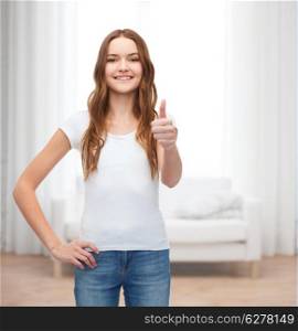 t-shirt design concept - smiling teenager in blank white t-shirt showing thumbs up