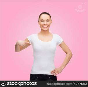t-shirt design concept - smiling woman in blank white t-shirt pointing at herself