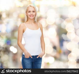 t-shirt design concept - smiling woman in blank white tank top