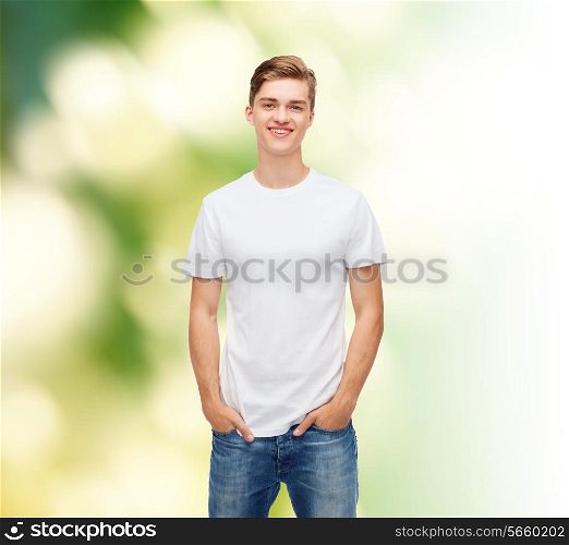 t-shirt design, ecology and advertising people concept - smiling young man in blank white t-shirt over green background