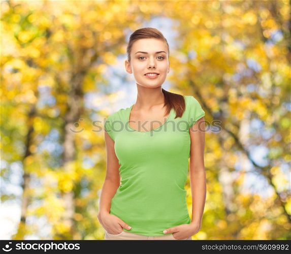 t-shirt design, education and people concept - smiling young woman in blank green t-shirt