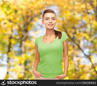 t-shirt design, education and people concept - smiling young woman in blank green t-shirt