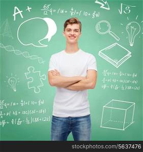 t-shirt design, education, school, advertising and people concept - smiling young man in blank white t-shirt over green board background with doodles