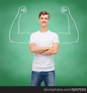 t-shirt design, education, school, advertising and people concept - smiling young man in blank white t-shirt over green board background strong arms drawing