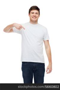t-shirt design, gesture and people concept - smiling young man in blank white t-shirt pointing finger on himself