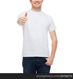 t-shirt design, gesture and people concept - smiling young man in blank white t-shirt showing thumbs up