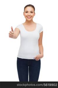 t-shirt design, gesture and people concept - smiling young woman in blank white t-shirt showing thumbs up
