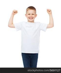 t-shirt design, strength, health, sport and fitness concept - little boy in blank white t-shirt showing muscles