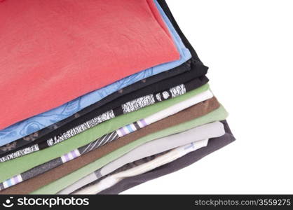 T-Shirts folded and stacked in variety of colors isolated on white