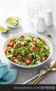 Tabbou≤h salad. Tabouli salad with fresh pars≤y, onions, tomatoes, bulgur andχckpea. Hea<hy ve≥tarian food, mediterra≠an diet