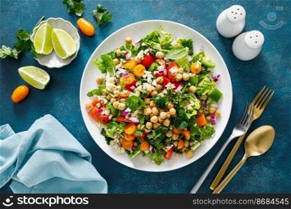 Tabbouleh salad. Tabouli salad with fresh parsley, onions, tomatoes, bulgur and chickpea. Healthy vegetarian food, diet. Top view