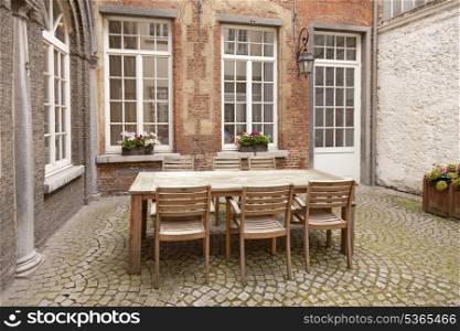 Table and chairs in patio, vintage style&#xA;