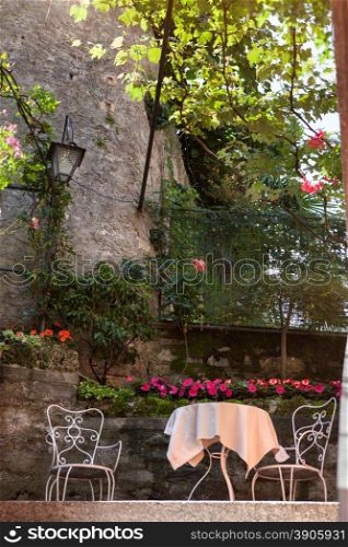 table and chairs in summer italian garden