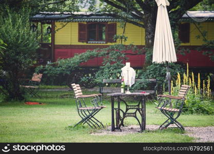 Table and chairs on a lawn at the garden