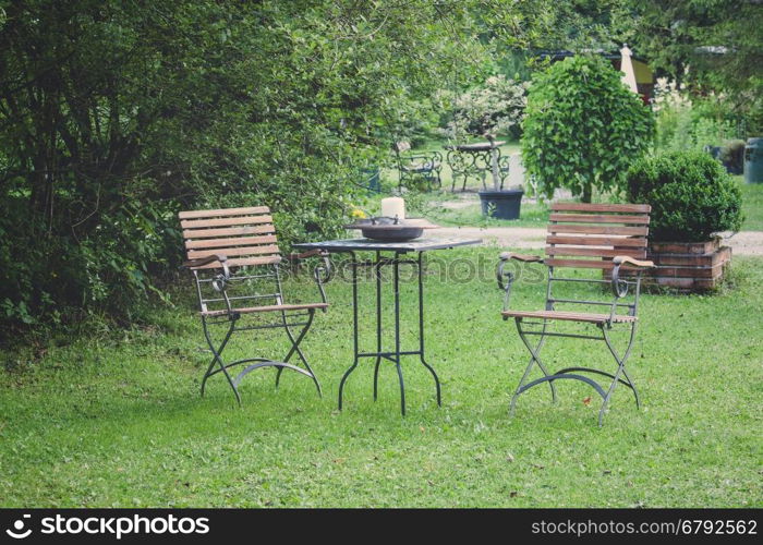 Table and chairs on a lawn at the garden
