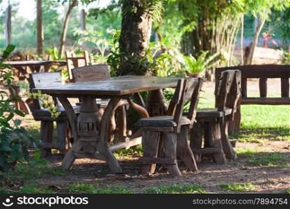 Table and chairs on the lawn. In the space relaxation with tropical trees.