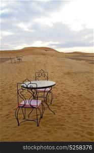 table and seat in desert sahara morocco africa yellow sand