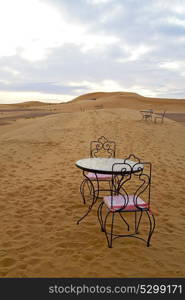 table and seat in desert sahara morocco africa yellow sand