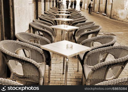 Table and wicker chairs of cafe in Valladolid, Spain