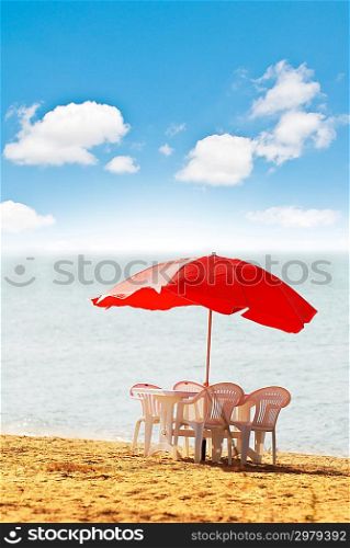 Table, chairs and parasol on the beach
