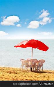 Table, chairs and parasol on the beach