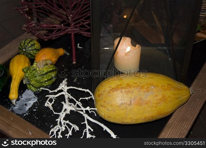 table decorated for halloween with pumpkins and a candle