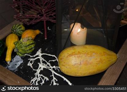 table decorated for halloween with pumpkins and a candle