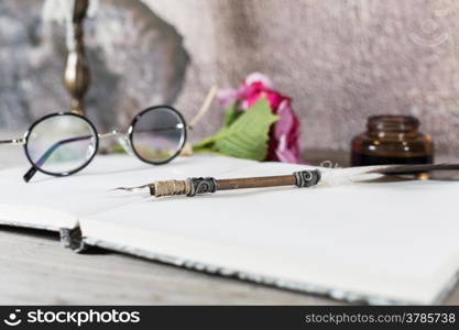 Table desk with an old pen and candle