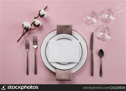 table etiquette with pink background flat lay