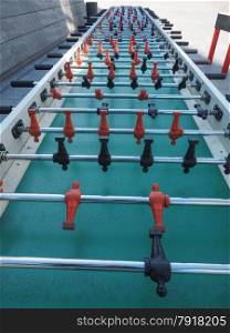 Table football. Table football aka table soccer, foosball from the German Tischfussball, baby-foot or kicker table-top game and sport