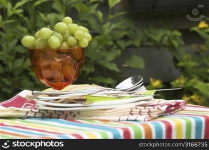 Table for two setout with a nice bowl of green grapes and plates ready