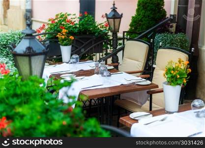 table in a street cafe with crockery and tablecloth close-up