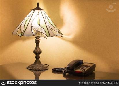 table lamp and phone on desk