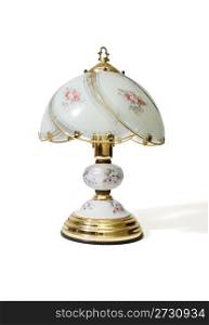 Table lamp under the glass lampshade with flower pattern isolated
