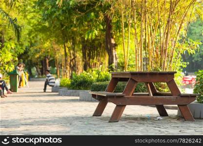 Table on the sidewalk. Within the zoo. People to stroll and relax during the holidays.