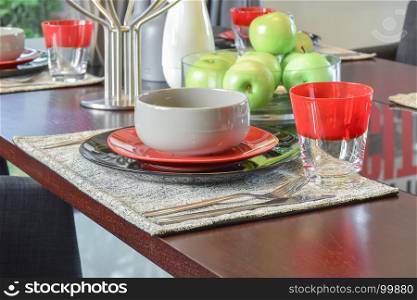 table set on wooden dining table in modern style dining room interior