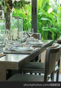 table set on wooden table and chairs in tropical dinning room