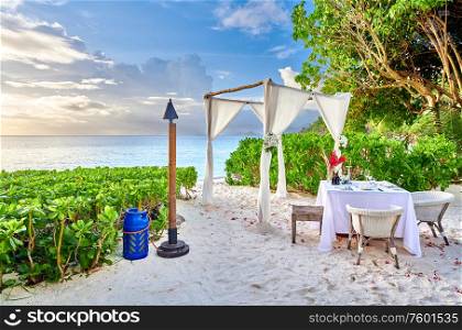 Table set up for romantic dinner on beach at Mahe, Seychelles