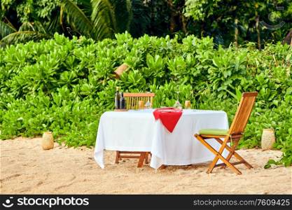 Table set up for romantic dinner on beach at Mahe, Seychelles