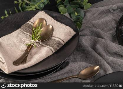 Table setting background with copy space. Background with napkin, silverware and rosemary branch. Cutlery with spoon.