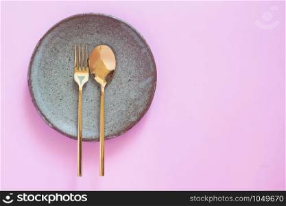 Table setting, Ceramic dishwear, spoon and fork on pink pastel color background