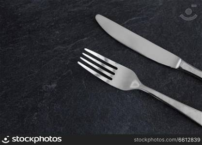 table setting, cutlery and eating concept - close up of fork and knife. close up of fork and knife on table