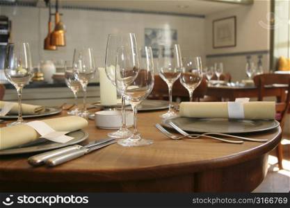 Table setting in a restaurant (shallow DOF, focus on the glasses in front)