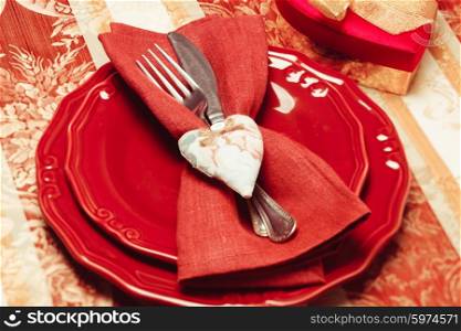 Table setting performed in red and gold for Valentine dinner. Valentine day table setting