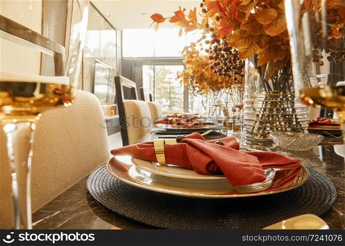 Table setting with autumn decorations, glasses and plates. Holidays, catering and hospitality concept.