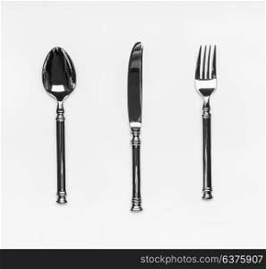 Table silverware cutlery setting with fork,knife and spoon on white background, top view