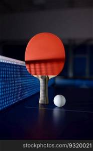 Table tennis equipment on blue ping pong table with grid net. Sport club and training class for skills improvement. Tennis still life. Table tennis equipment on blue ping pong table with grid net