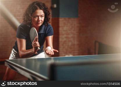 Table tennis, female player with racket hits ball. Ping pong training indoor, high concentration sport game. Table tennis, female player with racket hits ball