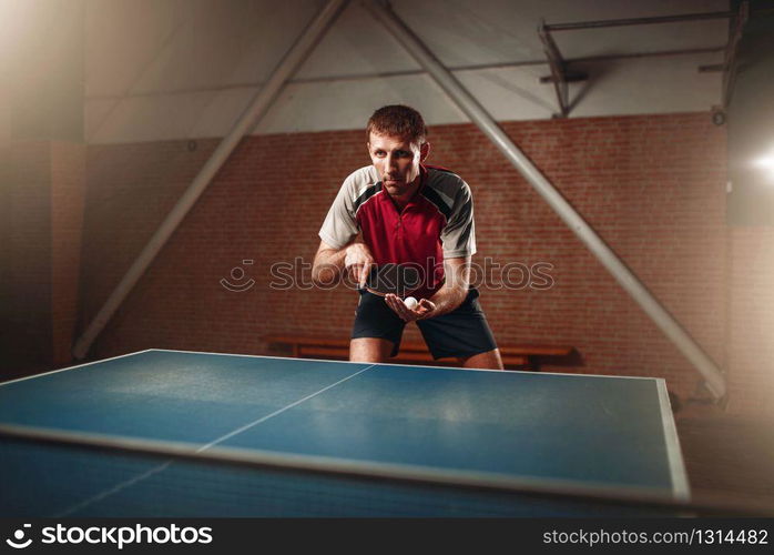 Table tennis, male player with racket and ball. Ping pong training indoor. Table tennis, male player with racket and ball