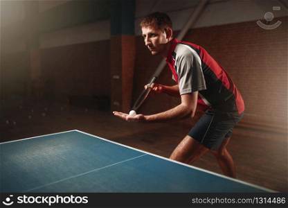 Table tennis, male player with racket and ball. Ping pong training indoor